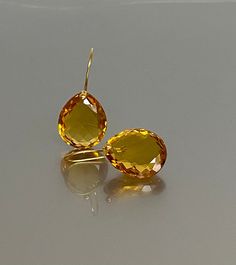 Gorgeous sparkly Citrine teardrop earrings. The Citrine drops are Flawless and have beautiful rich golden yellow color. The drops are attached to24k Gold 14K SOLID GOLD ear wires.  The earrings are elegant, and bold, and make a statement. A truly gorgeous pair of earrings. When 14K SOLID GOLD ear wires are being used, the ear wire ends are hand-stamped as proof of being 14K solid gold. In addition, extra work was done at the end of the ear wires to prevent any sort of pain or injury while inserting them through the ear lobes. **The 14K WHITE solid gold ear wires are RHODIUM plated to prevent tarnish of the ear wires over time. * Quality: Superb AAA+ Flawless Citrine * Carat (45 ct.) * Birthstone: November * Stone Shape: Teardrop Shape * The dimension of the stones: 22mmX18 / 0.9X0.7 inch * November Stone, Extra Work, Golden Yellow Color, Citrine Jewelry, Types Of Gemstones, November Birthstone, Large Earrings, Bold Design, Golden Yellow