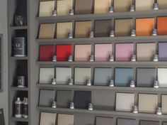 there are many different colors of paint on the shelves