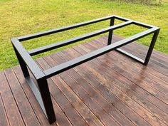 a metal frame sitting on top of a wooden deck