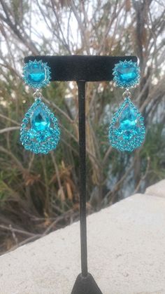 Turquoise Earrings For Evening, Blue Rhinestone Earrings For Evening, Blue Crystal Chandelier Earrings For Party, Glamorous Blue Chandelier Earrings For Party, Turquoise Drop Crystal Earrings For Party, Blue Glamorous Crystal Earrings For Evening, Glamorous Blue Crystal Earrings For Evening, Blue Jeweled Crystal Earrings For Party, Light Blue Dangle Crystal Earrings For Party