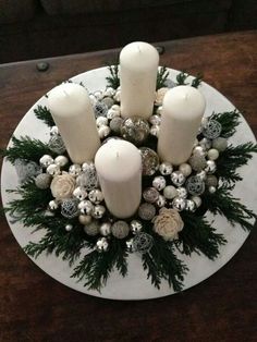 a white plate topped with candles and ornaments