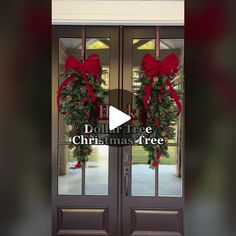 two christmas wreaths on the front door of a house with red bows and pine cones