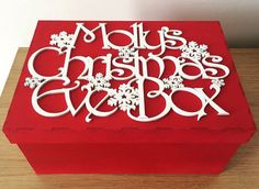 a red box with white letters and snowflakes on it