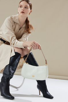 The Carrie Shoulder Bag has a vintage-inspired look with a gentle curve and slim structured silhouette. The signature belt loop detail allows for the strap to be lengthened for a hands-free style or carried on hand. Optional Add-ons: Charmed Chain. Luxury Shoulder Baguette Bag With Adjustable Handle, Luxury Baguette Shoulder Bag With Single Strap, Luxury Baguette Bag With Single Shoulder Strap, Elegant Clutch-style Baguette Bag With Adjustable Strap, Elegant Clutch Baguette Bag With Adjustable Strap, Elegant Beige Baguette Bag, Classic Clutch Baguette Bag With Detachable Handle, Luxury Evening Baguette Bag With Single Shoulder Strap, Luxury Evening Baguette Bag With Single Strap