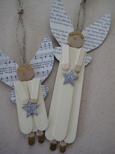 two wooden angel ornaments hanging from twine