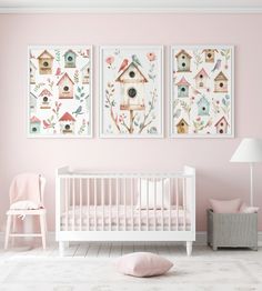 a baby's room with pink walls and two pictures hanging on the wall above it