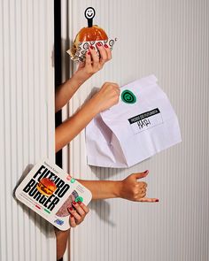 two women holding up paper bags with different designs on them