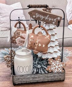 a christmas display with gingerbread cookies and other holiday decorations in a metal holder on a wood floor