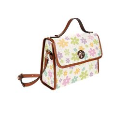 "Introducing our Retro Floral Handbag - a chic and mod-inspired accessory that adds a touch of 60s style to your ensemble. This Multicolor Pastel Floral Bag is designed for those who appreciate the whimsy of vintage fashion. With a delightful mod floral pattern print in green, pink, purple, blue, and yellow, this Floral Purse captures the vibrant and playful spirit of the era. Crafted as a crossbody bag with a strap to wear over the body, this 60s Style Handbag effortlessly combines fashion and functionality. The mod-inspired floral pattern brings a sense of nostalgia, while the pastel colors add a fresh and stylish element. Elevate your look with this Retro Floral Handbag, a Vintage Style Handbag that complements various outfits, making it a versatile and eye-catching choice for any occas Retro Handheld Box Bag, Retro Box Shoulder Bag With Removable Pouch, Retro Shoulder Box Bag With Removable Pouch, Retro Crossbody Shoulder Bag For Spring, Retro Box Bag With Removable Pouch, Floral Print Top Handle Bag For Travel, Retro Shopping Box Bag With Removable Pouch, Retro Top Handle Box Bag, Retro Satchel Box Bag With Top Carry Handle