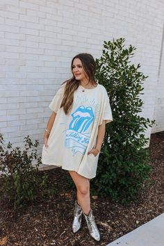 Elevate your wardrobe with our Cream Rolling Stones T-Shirt Dress! Made from high-quality materials, this dress features a classic Rolling Stones graphic that will make a statement wherever you go. Comfortable and stylish, this dress is perfect for any occasion. Embrace your love for music and dress to impress! Model wearing a small. Cotton Graphic Print T-shirt Dress With Short Sleeves, White Cotton T-shirt Dress With Graphic Print, Summer Dresses With Graphic Print And Relaxed Fit, White Graphic Print T-shirt Dress With Crew Neck, White Crew Neck T-shirt Dress With Graphic Print, Cotton Graphic T-shirt Dress With Short Sleeves, Cotton Graphic Print Short Sleeve T-shirt Dress, Retro Cotton Dress With Graphic Print, Oversized Cotton T-shirt Dress With Graphic Print