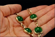 "This is a very beautiful, old and unique PEKING GLASS GILDED SILVER c. 1940 bracelet. The bracelet has a marvelous Peking glass with deep green color (11 x 11 mm) with gilded silver. It measures 7\" x 1/2\". The bracelet has a very unique and elegant feel to it and is in very good condition. 0.7 AOJFPC-806-124" Victorian Green Bracelets As Gift, Victorian Green Bracelets For Gifts, Victorian Style Green Bracelets For Gifts, Elegant Green Cabochon Bracelets, Green Cabochon Bracelet For Formal Occasions, Green Cabochon Bracelets For Formal Occasions, Art Deco Jade Jewelry For Formal Occasions, Formal Green Cabochon Bracelets, Formal Green Cabochon Bracelet