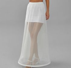 a woman is wearing a white skirt with sheer gauze on the bottom and side