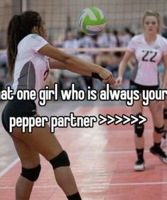 two girls are playing volleyball and one girl is about to hit the ball