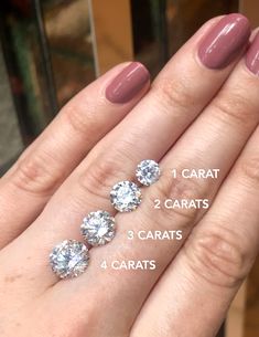 a woman's hand with three carats and four carats on it