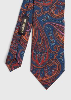 Silk bold color printed paisley tie.. Paul Stuart is one of the oldest and most well respected names in fashion, offering exclusive and custom tailored clothing, sportswear, footwear and accessories for men and women. Renowned for expert craftsmanship, thoughtful design using materials and fabrics sourced from the finest mills around the world, Paul Stuart combines Savile Row, Old Hollywood and a very distinct New York vibe to create timeless American classics with contemporary sophistication. Multicolor Paisley Print Suit And Tie Accessories For Business, Elegant Multicolor Paisley Print Ties, Formal Multicolor Paisley Suit And Tie Accessories, Classic Paisley Print Patterned Ties, New York Vibes, Paisley Tie, Savile Row, Bold Color, Off Black