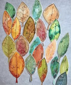 a painting of many different colored leaves on a gray background with watercolors and ink