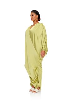 TIBARA floor length kaftan dress is a stunning drape that swoops around from shoulder to shoulder. Back in a striking lime hue, it is a simple style that catches the sunlight in no simple way. 97 % Polyester, 3% Spandex Full length Tapered sleeve Pleated details Center front snap closure Handwash cold, line dry Oversized fit Model (S) is 5 ft 10 in and wearing a size S/M Model (XL) is 5 ft 9in and is wearing a size L/XL Green Maxi Dress With Draped Sleeves, Summer Asymmetrical Maxi Dress With Draped Sleeves, Green Draped Beach Dress, Andrea Iyamah, 20's Dress, Kaftan Dress, Dress Cover, Simple Way, Simple Style