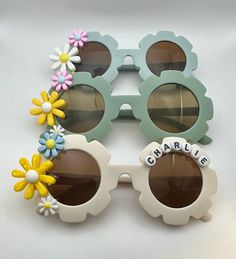 Personalized girls sunnies with 3 daisies. Flower colors may vary. Name or phrase can be added in white beads with black letters or colored beads with gold letters. Personalized Sunglasses, Flower Colors, Mobile Boutique, Disco Party, Black Letter, Gold Letters, White Beads, Eyewear Sunglasses, Colorful Flowers