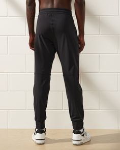 Our new slim-fitting training joggers in a high stretch, quick-dry fabric, that's super soft and breathable with 4-way stretch, anti-abrasion and moisture-wicking properties, and a tapered fit, with room through the thighs and seat and tapered through the calf with cuff bottom. Features an elasticated waistband with exterior drawcords, laser-cut ventilation at knees, side pockets with hidden zipper pocket for extra security and zippers at cuffs. Perfect for all workouts, but clean enough to prov Workout Wardrobe, Mens Joggers, Intense Workout, Mens Bottom, Hidden Zipper, Abercrombie Fitch, Quick Dry, Moisture Wicking, The Man