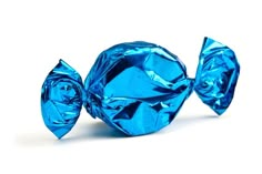 two pieces of blue foiled candy sitting next to each other on a white surface