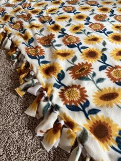 a sunflower print bed spread with ruffles on the bottom and bottom edge