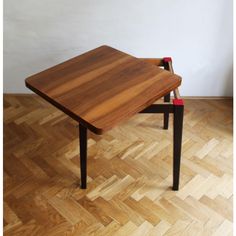 a wooden table sitting on top of a hard wood floor