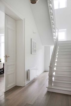 an empty room with stairs leading up to the second floor