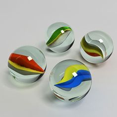 four glass knobs with different colors on them