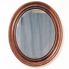 a round mirror hanging on the wall