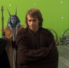 two men standing next to each other in front of a green screen with the same character