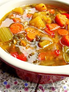 a bowl of soup with carrots and other vegetables