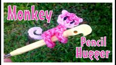 a pink crochet hook with the words monkey pencil hugger