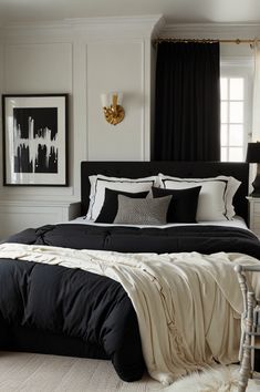 a bedroom with black and white bedding in it