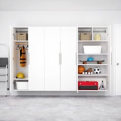 a room with white cupboards and sports equipment