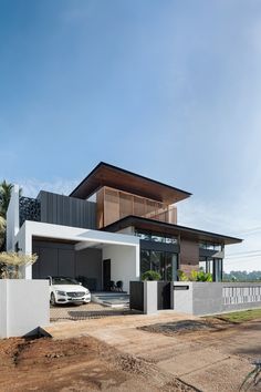 a car is parked in front of a modern house