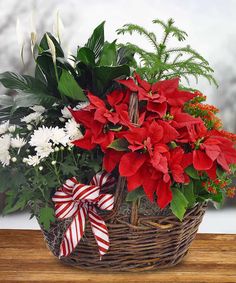 a basket filled with red and white flowers