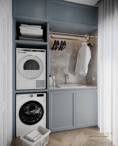 a washer and dryer in a laundry room with blue cabinets on the wall