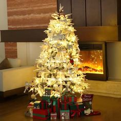 a white christmas tree with presents under it