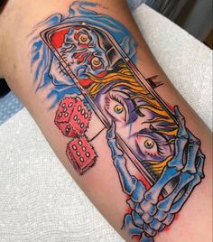 a colorful tattoo on the arm of a woman with dices in front of her face