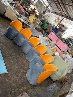 several different colored chairs sitting on the floor in a room with lots of other furniture