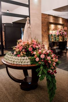 an arrangement of flowers and marshmallows sits on a table in the lobby