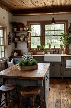 a kitchen with wooden floors and lots of counter space, including a large center island