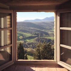 an open window looking out onto the countryside