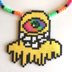 a beaded necklace with an image of a yellow monster on it's chest