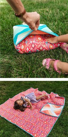 a woman laying on top of a pink and blue blanket in the grass next to a child