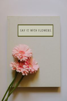 a card with pink flowers on it says say it with flowers, and there is no image here to provide a caption for