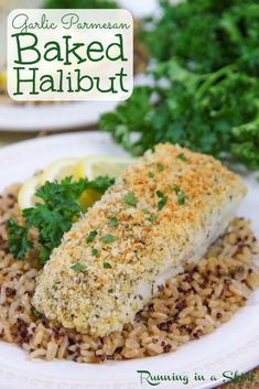 baked halibut with parsley and brown rice on a white plate next to lemon wedges