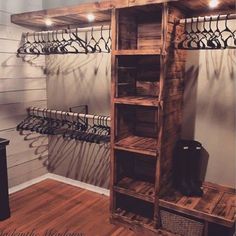 a wooden shelf with several pairs of shoes hanging from it's sides and some hangers on the wall