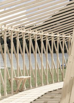 a wooden bench sitting on top of a grass covered field