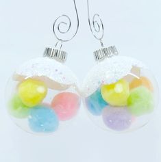 a pair of earrings with gummy balls in them